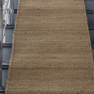 Handmade natural jute stair runner rug made from durable hemp and jute fibers, perfect for custom stairways and hallways. This eco-friendly, rustic runner features a minimalist woven texture ideal for farmhouse, boho, or modern decor. Perfect as a custom-size rug or stair carpet, it brings warmth, sustainability, and a natural touch to any interior space. Designed for high-traffic areas and handcrafted with care.