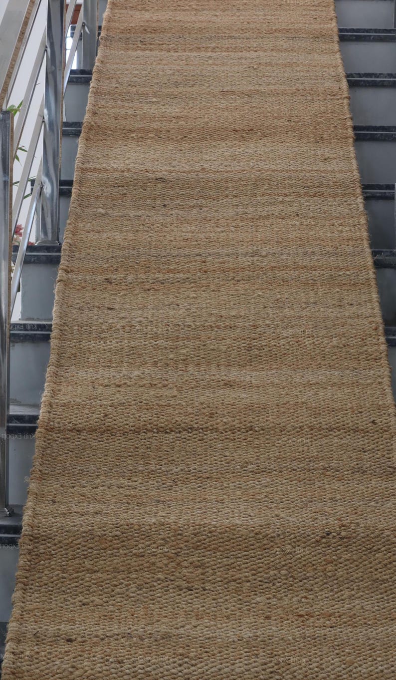 Handmade natural jute stair runner rug made from durable hemp and jute fibers, perfect for custom stairways and hallways. This eco-friendly, rustic runner features a minimalist woven texture ideal for farmhouse, boho, or modern decor. Perfect as a custom-size rug or stair carpet, it brings warmth, sustainability, and a natural touch to any interior space. Designed for high-traffic areas and handcrafted with care.