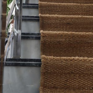 Handmade natural jute stair runner rug made from durable hemp and jute fibers, perfect for custom stairways and hallways. This eco-friendly, rustic runner features a minimalist woven texture ideal for farmhouse, boho, or modern decor. Perfect as a custom-size rug or stair carpet, it brings warmth, sustainability, and a natural touch to any interior space. Designed for high-traffic areas and handcrafted with care.