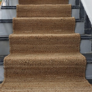 Handmade natural jute stair runner rug made from durable hemp and jute fibers, perfect for custom stairways and hallways. This eco-friendly, rustic runner features a minimalist woven texture ideal for farmhouse, boho, or modern decor. Perfect as a custom-size rug or stair carpet, it brings warmth, sustainability, and a natural touch to any interior space. Designed for high-traffic areas and handcrafted with care.