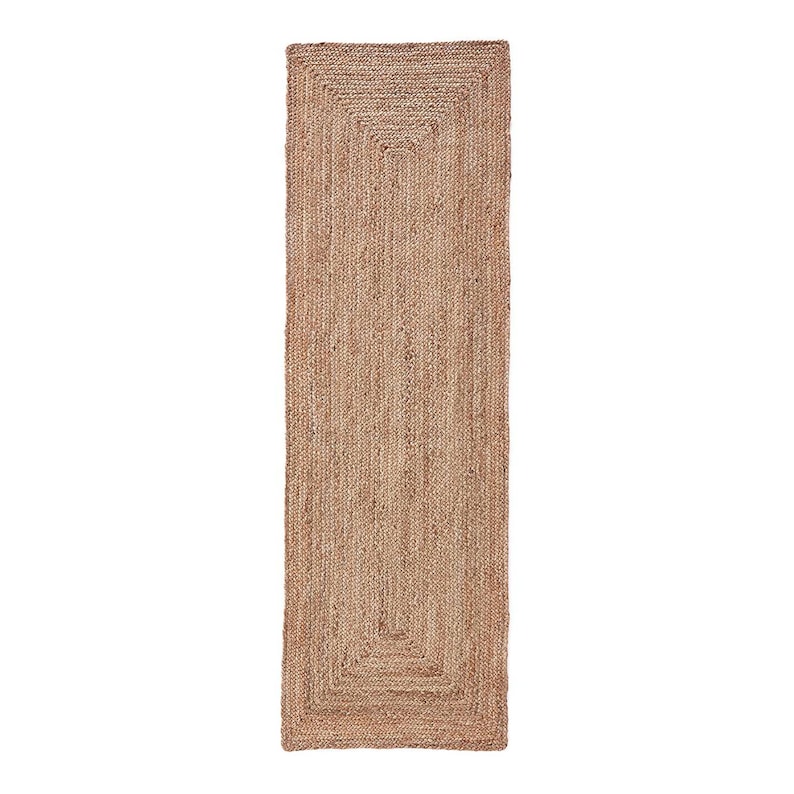 May include: A natural fibre rug with a rectangular shape and a braided design. The rug has a light brown colour and a subtle texture.