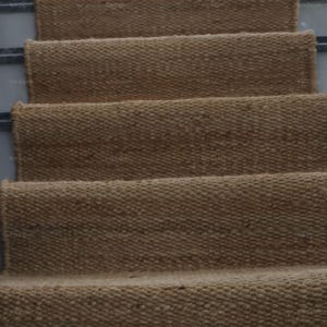 Handmade natural jute stair runner rug made from durable hemp and jute fibers, perfect for custom stairways and hallways. This eco-friendly, rustic runner features a minimalist woven texture ideal for farmhouse, boho, or modern decor. Perfect as a custom-size rug or stair carpet, it brings warmth, sustainability, and a natural touch to any interior space. Designed for high-traffic areas and handcrafted with care.