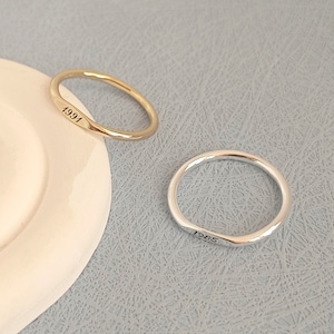 以下が含まれることがあります： 1991年と1985年が刻まれた、シンプルなゴールドとシルバーのリング2つ