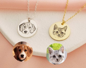 May include: Two silver and gold necklaces with engraved pet portraits. The silver necklace features a beagle dog and the gold necklace features a tabby cat.