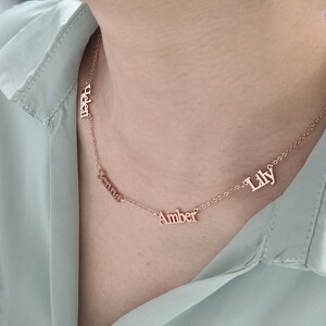 Op de afbeelding: Een ketting van roségoud met vier namen: Helen, Jenna, Amber en Lily.