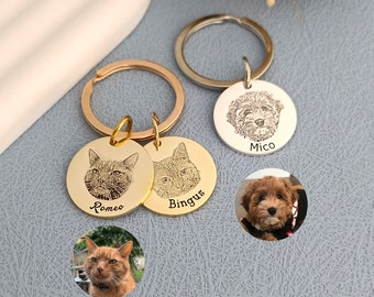 May include: Two gold keychains with engraved pet portraits. One keychain has a cat portrait with the name "Romeo" and the other has a cat portrait with the name "Bingus". A silver keychain with a dog portrait and the name "Mico" is also shown.