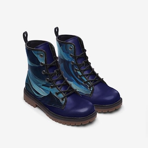 May include: A pair of blue and black lace-up boots with a blue and white abstract pattern. The boots have a round toe and a thick sole.