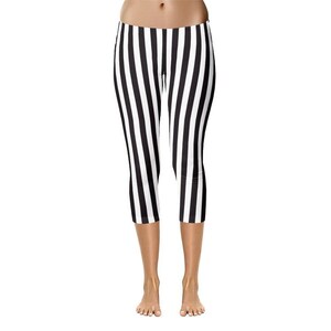 May include: Capri-length leggings featuring a bold vertical striped pattern in alternating black and white colors. The garment has a fitted silhouette that extends to the mid-calf, showcasing a clean, high-contrast design throughout the fabric.