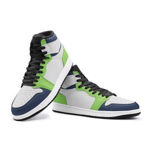 May include: High-top sneakers in a modern design. The shoes feature a combination of white, gray, blue, and green panels. Black laces and a white sole complete the look. A stylish and contemporary footwear option.