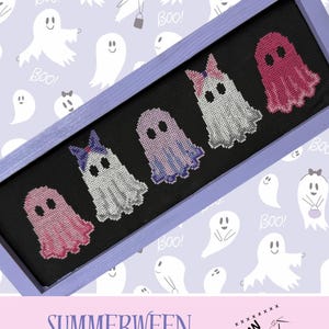 May include: A cross-stitch artwork featuring six ghost figures in a purple frame. The ghosts are in shades of pink, purple, and white, some with bows. The background is a light purple with ghost illustrations and the word "Boo!". The text "SUMMERWEEN GHOST" is at the bottom.