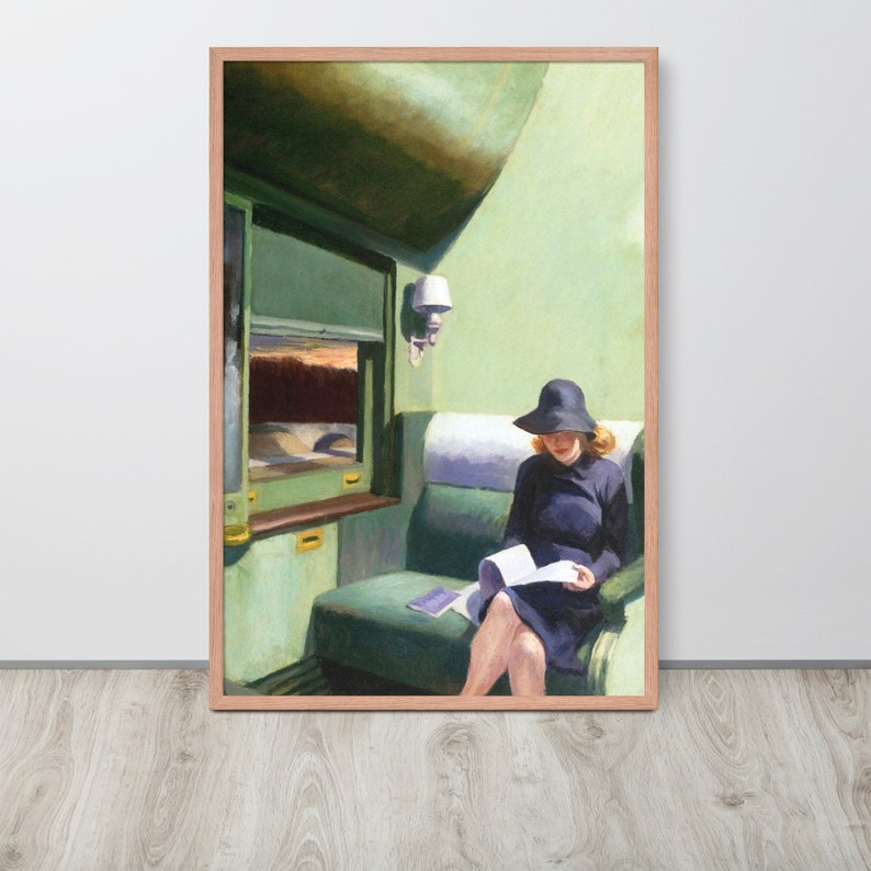 May include: A woman in a black hat and dress sits on a green train seat reading a book. The train car is painted in shades of green with a window looking out to a landscape.