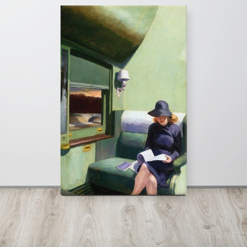 May include: A woman wearing a black hat and a blue dress sits in a green train compartment, reading a book. The train window shows a view of a bridge and a sunset.