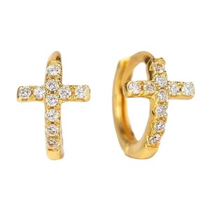 May include: A pair of gold-colored hoop earrings, each featuring a cross design. The crosses are encrusted with small, sparkling clear stones, creating a glamorous and religious-themed accessory. The earrings are set against a white background.