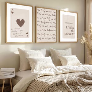 May include: Three framed wall art prints with light beige backgrounds and dark brown text. The left print shows an ace of hearts playing card. The centre print repeats the phrase How lucky are we. The right print displays the text NOTE TO SELF: LIVE in the MOMENT.