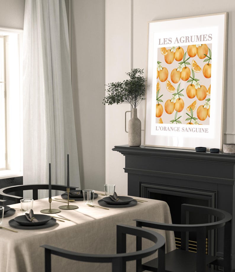 May include: A black and white print with a graphic of oranges and leaves. The print has the text "Les Agrumes L'Orange Sanguine" in white.