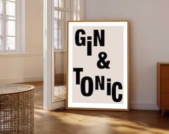 May include: A rectangular framed wall art print featuring a light beige background with bold black typography. The text reads GIN & TONIC in a stacked, sans-serif font style. The frame is a light wood colour, providing a clean and simple border.