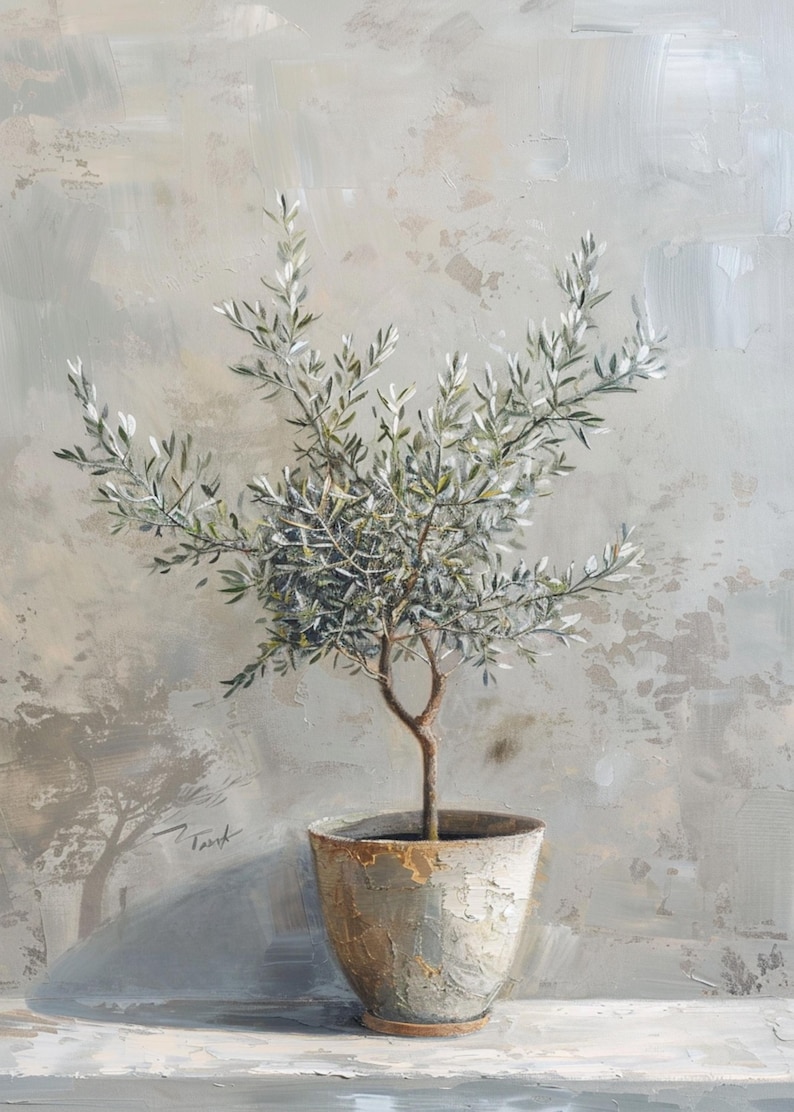 May include: A small olive tree with green leaves in a gray ceramic pot with a rough texture. The pot is sitting on a light gray surface.