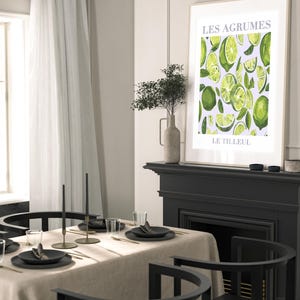 May include: A framed print with a white background and a green citrus fruit pattern. The text "LES AGRUMES" and "LE TILLEUL" is printed in gray at the top and bottom of the print.