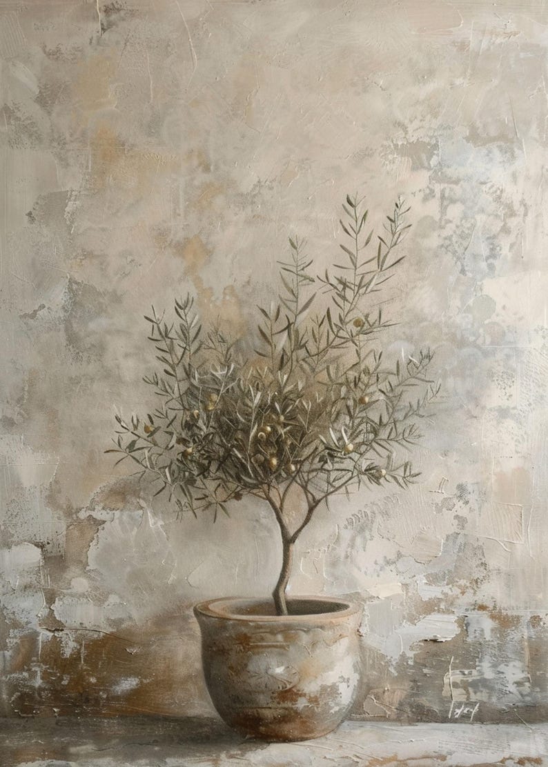 May include: A small olive tree with green leaves and small, golden olives is potted in a rustic, gray ceramic pot. The tree is set against a textured, beige wall.