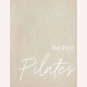 May include: A beige-toned print with the words "But First, Pilates" in white script. The background has a textured appearance, and the text is centered on the print.