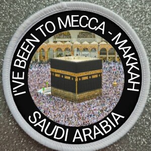 May include: A circular embroidered patch with a white border. The center features a photographic image of the Kaaba in Mecca surrounded by a crowd. The black border contains the white text: I'VE BEEN TO MECCA - MAKKAH SAUDI ARABIA.