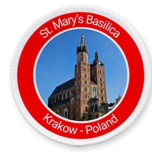 May include: A red and white circular patch with a photo of St. Mary's Basilica in Krakow, Poland. The text "St. Mary's Basilica Krakow - Poland" is printed on the patch.