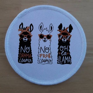 May include: White round patch with three black llamas wearing sunglasses and bandanas. The llamas have text below them that reads "No Drama Llama", "No Prob Llama", and "Oh La La Llama".
