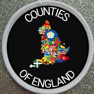 May include: A white circular patch with a black background. The patch features a map of England with the flags of each county superimposed on it. The text "COUNTIES OF ENGLAND" is written in a white circle around the map.