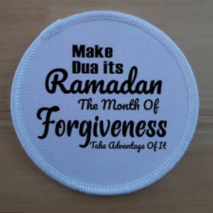 May include: White round fabric patch with black text that reads "Make Dua its Ramadan The Month Of Forgiveness Take Advantage Of It"