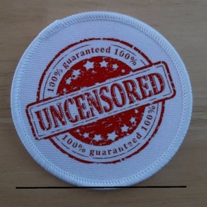 May include: White round patch with red stitching around the edge. A red circle with the text "100% guaranteed 100%" and the word "UNCENSORED" in the center.