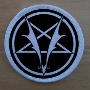 May include: White embroidered patch with a black circle containing a white pentagram with a white inverted cross and two white wings.