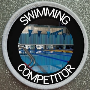 May include: A white and black round patch with the words "Swimming Competitor" around a photo of a swimming pool.