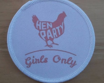 May include: White round fabric patch with pink stitching around the edge. The patch features a pink silhouette of a chicken with the words "Hen Party" inside the silhouette. Below the chicken is the text "Girls Only" in pink.