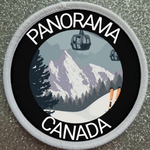May include: A circular embroidered patch with a white border featuring a mountain landscape, a ski lift with gondolas, and pine trees. The text PANORAMA is printed in white at the top and CANADA is printed in white at the bottom on a black background.