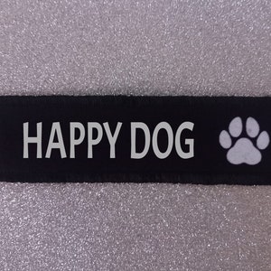 May include: Black fabric patch with white text that reads "HAPPY DOG" and a white paw print.