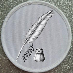 May include: A round, gray patch with a white stitched border. The patch features a detailed black and white illustration of a quill pen, an inkwell, and the word "POETRY" in a script font.