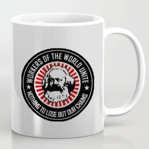 May include: White ceramic mug with a black and red circular design featuring a portrait of Karl Marx and the text "Workers of the World Unite Nothing to Lose But Our Chains".