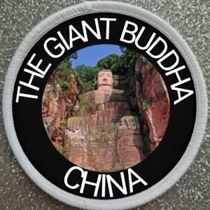 May include: A white and black circular patch with the text "THE GIANT BUDDHA CHINA" around a photo of a large stone Buddha statue carved into a cliffside.