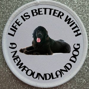 May include: White round patch with black text that reads "Life is better with a Newfoundland dog". A black Newfoundland dog is lying down in the center of the patch.