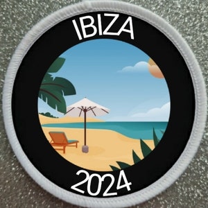 May include: A white round patch with a black circle in the center. The black circle has a beach scene with a palm tree, an umbrella, a lounge chair, and the ocean. The text "IBIZA 2024" is printed in white around the black circle.