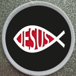 May include: White and red fish symbol with the word "JESUS" inside. The symbol is on a black background with a white border.