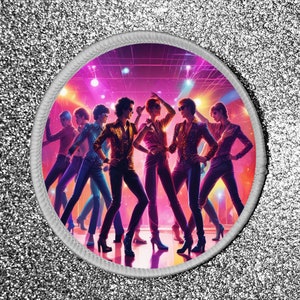 May include: A round patch with a white border and a colourful image of seven people dancing in a disco setting. The people are wearing sparkly clothing and are silhouetted against a pink and purple background with flashing lights.