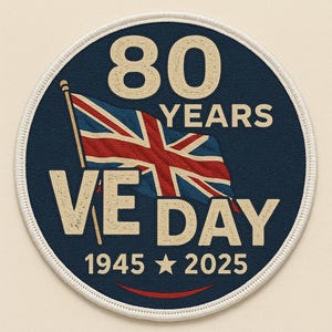May include: A round, blue patch with white stitching around the edge. The patch features a red, white, and blue Union Jack flag, the text "80 YEARS VE DAY 1945 2025", and a white star.