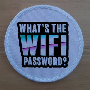 May include: White round patch with black text that says "What's the WIFI password?" The word "WIFI" is in a blue, pink, and white gradient.