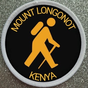May include: A white and black round patch with the text "Mount Longonot Kenya" in yellow. A yellow stick figure with a backpack is walking with a walking stick.