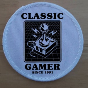 May include: White round patch with black text and a joystick graphic. The text reads "CLASSIC GAMER SINCE 1991".