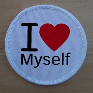May include: White round fabric patch with black text that reads "I love Myself" and a red heart.