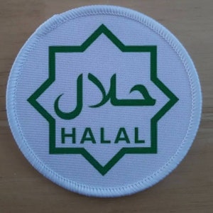 May include: A round, white patch with a green eight-pointed star design and the word "HALAL" in green below Arabic script. The patch has a white stitched border.