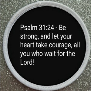 May include: A circular patch with a black centre and white text quoting Psalm 31:24: "Be strong, and let your heart take courage, all you who wait for the Lord!" It has a white border.