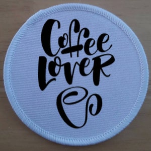 May include: White round fabric patch with black text that reads "Coffee Lover Co." and a stylized coffee cup graphic.